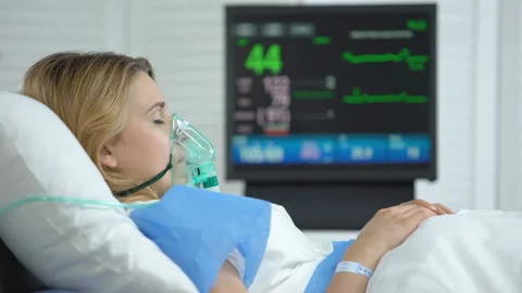 Female in coma, heart rate falling to zero on ecg monitor, patient death, health Stock Footage 114054191