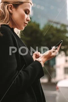 Female commuter using online transportation service Stock Photos