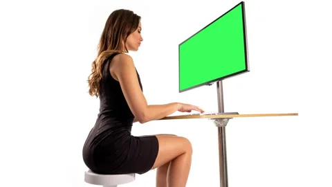Female on a computer with green screen | Stock Video | Pond5