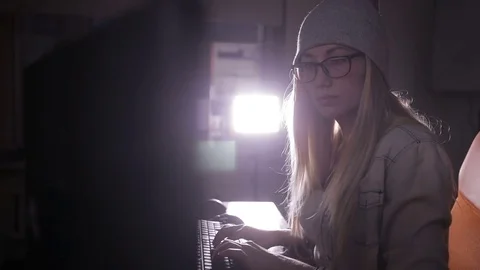Female computer programmer coding, hacking in dark room Stock Footage 69793911