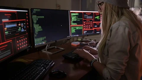 Female computer programmer coding, hacking in dark room Stock Footage 69794436