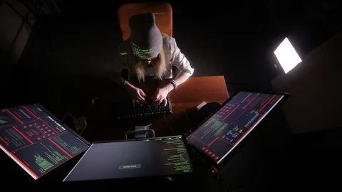 Female computer programmer coding, hacking in dark room Stock Footage 69794875