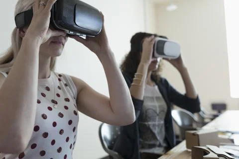 Female computer programmer designers testing virtual reality simulator glasses 写真素材