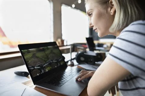 Female computer programmer programming virtual reality simulator at laptop Stock Photos