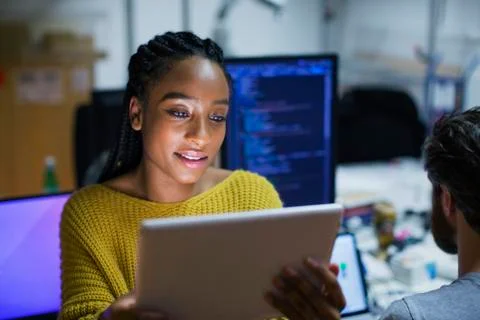 Female computer programmer using digital tablet in office Stock Photos