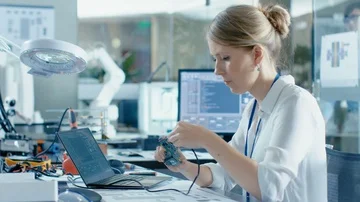 Female Computer Scientists Connects Circuit Board to Her Laptop Stock Footage 85769332