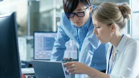 Female Computer Scientists Connects Circuit Board to Her Laptop Stock Footage 85771345