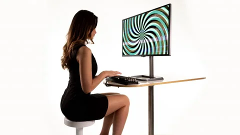 Female on a computer with spiral pattern Stock Footage 237195086