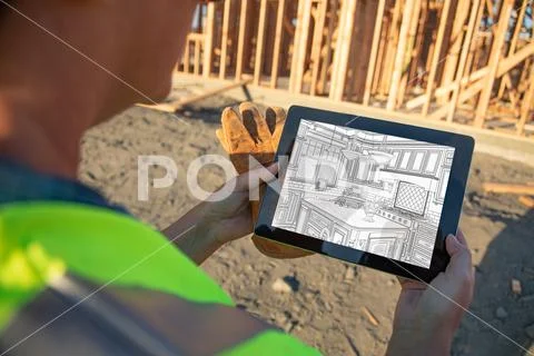 Female Construciton Worker Reviewing Kitchen Drawing on Computer Pad at Const Stock Photos