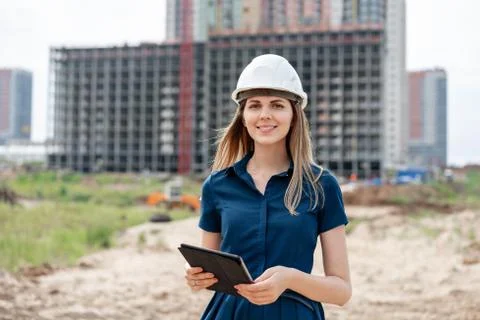 Female construction engineer. Architect with a tablet computer at a construction Stock Photos