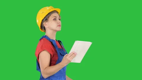 Female construction engineer looking at tablet and checking object on a Green Stock Footage 100056738
