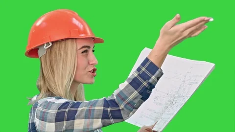 Female construction engineer reading plans and talk to workers on a Green Screen Stock Footage 73872726
