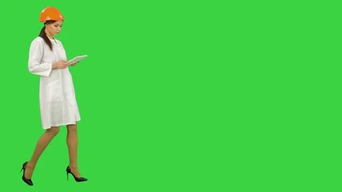 Female construction specialist in hardhat using tablet on a Green Screen, Chroma Stock Footage 71754585