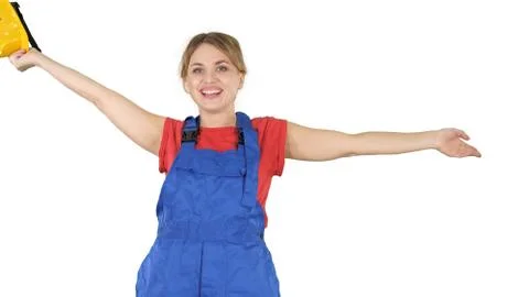 Female construction worker dancing with hardhat on white background. Stock Photos
