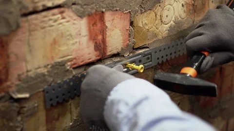 Female construction worker fixing galvanized steel drywall hangers for metal Stock Footage 330358517