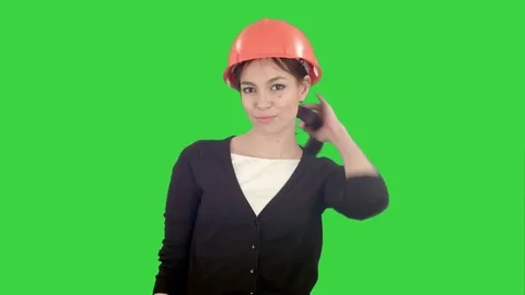Female construction worker in helmet making funny dancing on a Green Screen Vídeos de archivo 71754302