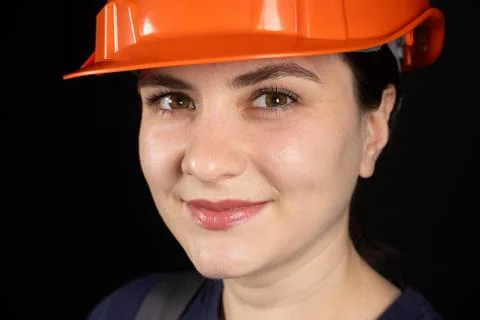 A female construction worker or engineer wearing a protective orange mask o.. Stock Photos