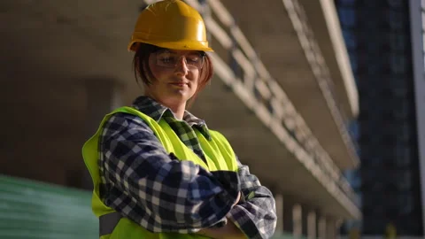 Female Construction Worker proudly showcasing her expertise on site Stock Footage 311860904