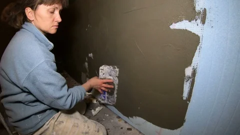 A female construction worker working on a wall insulation Video stock 120287831