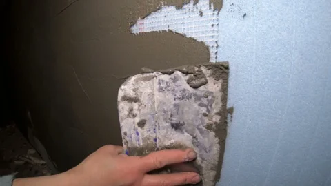 A female construction worker working on a wall insulation Vidéo 120287932