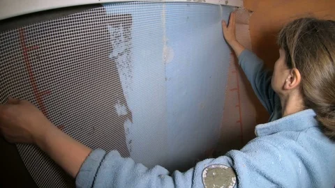 A female construction worker working on a wall insulation Video stock 120288019