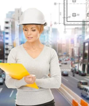 Female contractor in helmet with folder Stock Photos