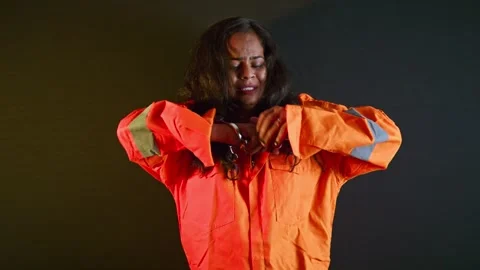 Female convict stands tense pulls tight chains Stock Footage 310290844