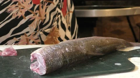 A female cook cleans raw fish. Healthy food concept 스톡 동영상 138006579