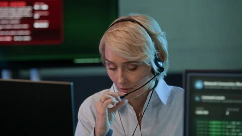 Female Coordinator in Headset Reporting about Cyberattack in Office Stock Footage 334935973