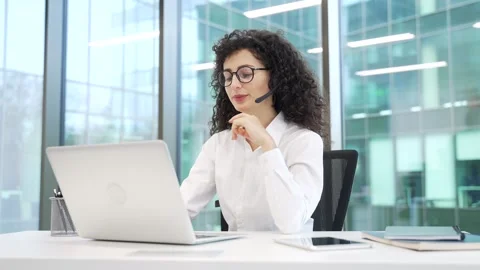 Female corporate operator in headset working in customer support service on help Stock Footage 319008808