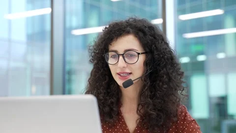 Female corporate operator in headset working in customer support service on help 스톡 동영상 334106754