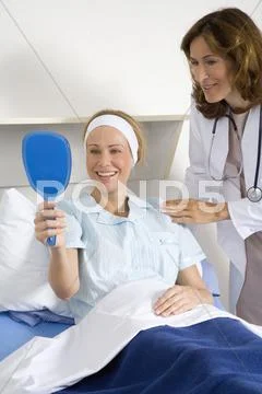 Female cosmetic surgeon talking to female patient Stock Photos