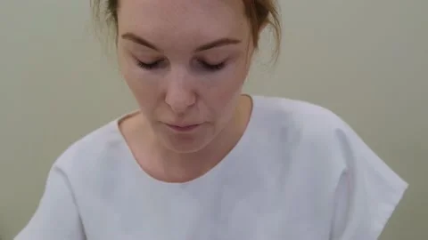 Female cosmetologist doing a microcurrent therapy procedure for a young patient. Stock Footage 218593268