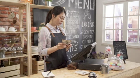 Female counting finances in small coffee shop Stock Footage 133399642