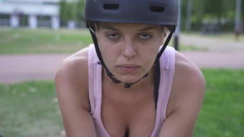 Female courier checking phone during bike delivery Stock Footage 325523503