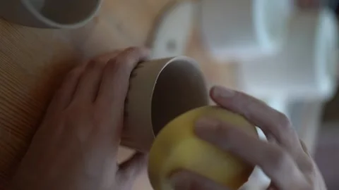 Female craftsman makes ceramic cups. Manual labor - Women's rights Stock Footage 252591902