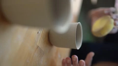 Female craftsman makes ceramic cups. Manual labor - Women's rights Stock Footage 252592057