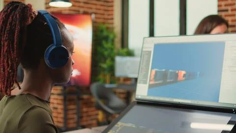 Female creative engineer using game programming software Stock Photos