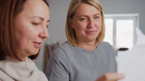 Female Creatives Observing Fabric Pattern and Smiling During Design Session Stock Footage 307136157
