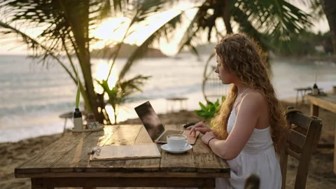 Female crypto trader at laptop checking candlestick charts online working Stock Footage 240021067