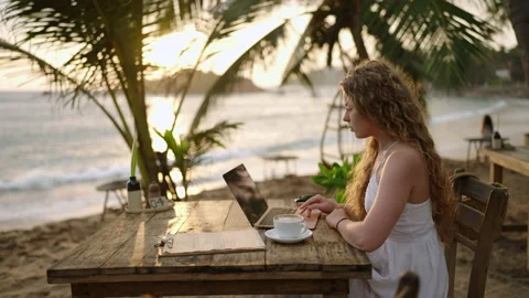 Female cryptocurrency trader at laptop checking candlestick charts online Stock Footage 234809707