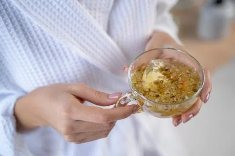 Female with a cup of chamomile tea Stock Photos