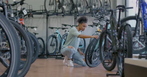 Female Customer Browsing Bicycle Store Stock Footage 253392385