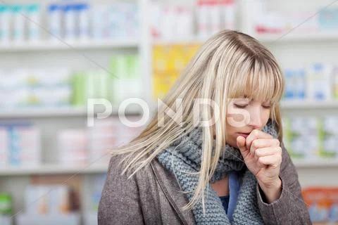 Female customer coughing in pharmacy Stock Photos