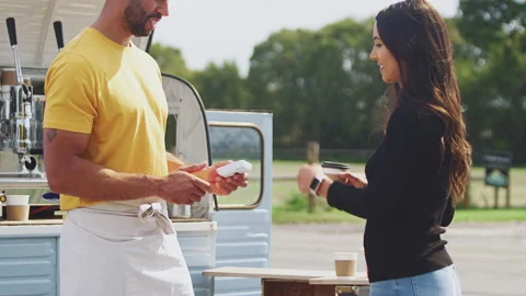Female Customer Making Contactless Payment Using Smart Watch At Mobile Coffee Stock Footage 143264352