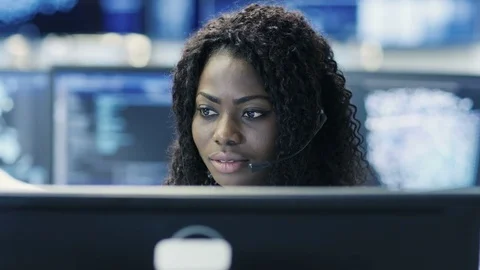 Female Customer Service Representative Answer Client's Questions in a Headset.  Stock Footage 81271392