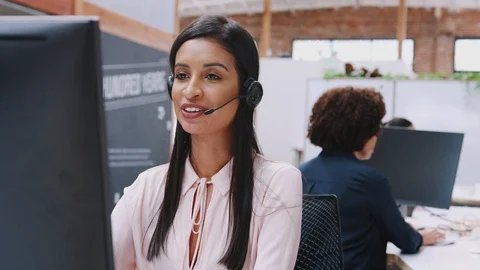 Female Customer Services Agent Working At Desk In Call Center Video stock 111924581