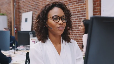 Female Customer Services Agent Working At Desk In Call Center Video stock 111924697