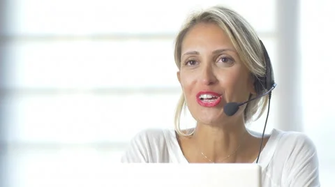 Female customer support operator with headset and smiling Stock Footage 42418558