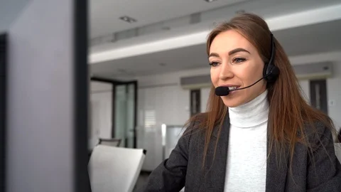 Female customer support operator with headset and smile Stock Footage 127418484